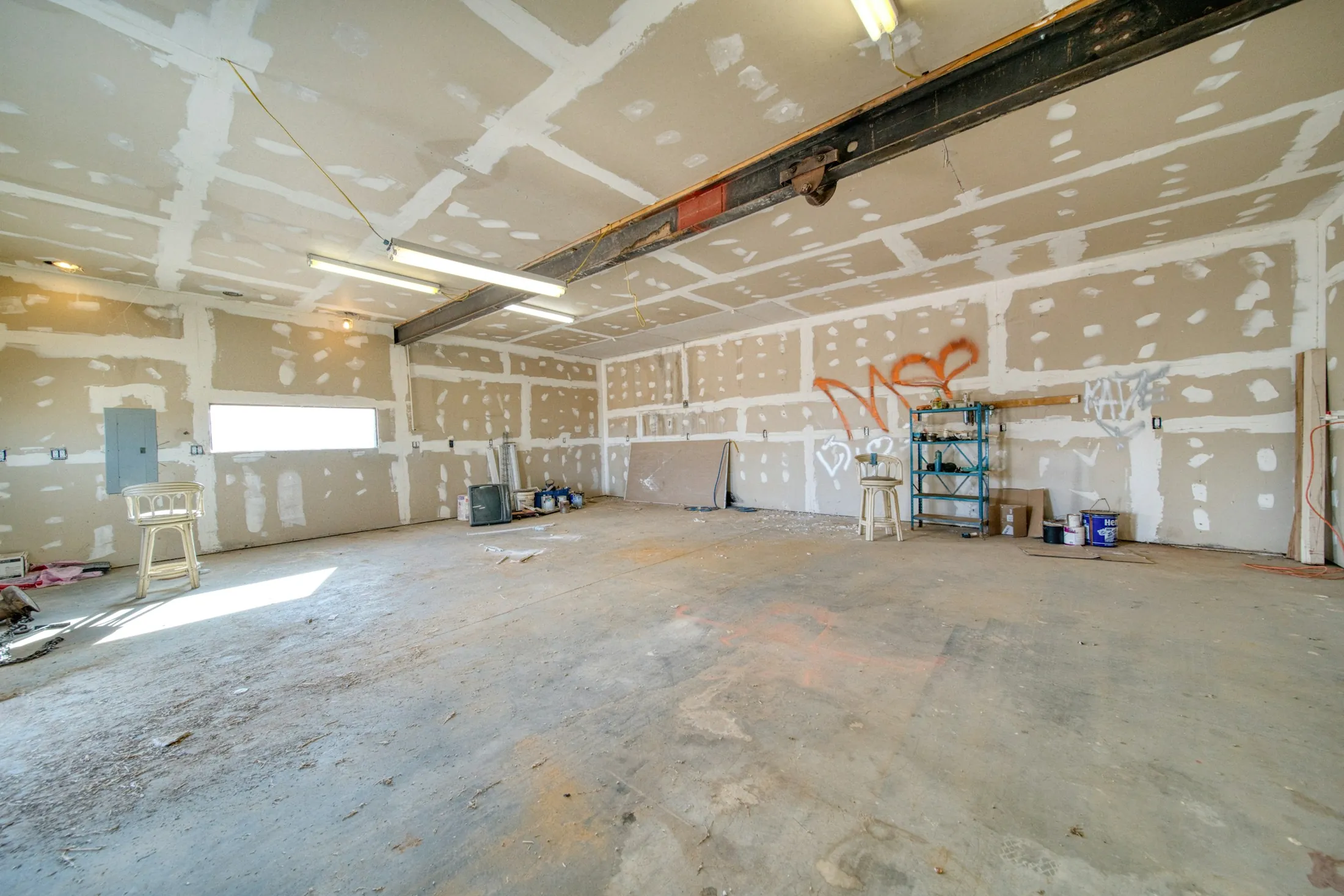 A fit-out space mid-construction with a work stool and tools